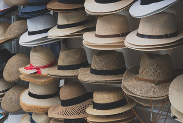 Variety of hats for sale in the market.