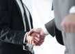 © ASDF - Friendly smiling businessmen handshaking. Business concept photo
