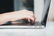 © Sergey - Closeup of woman’s hands typing on laptop at cafe outdoors. Freelance concept. Horizontal