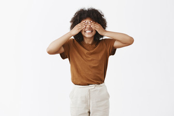 Wall Mural - studio shot of bright happy and young attractive african american short girl with afro hairstyle cov