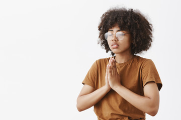 Wall Mural - waist-up shot of focused relaxed and calm attractive young dark-skinned female in glasses with afro 