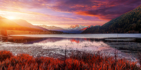 Aufkleber - Impressive sunset on Alpine lake. Overcast colorful clouds under sunlight of sunset on Famous lake Lago Della Muta.