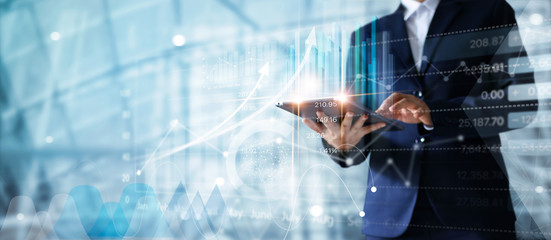 Leinwandbilder - Businessman using tablet analyzing sales data and economic growth graph chart.  Business strategy. Abstract icon. Digital marketing