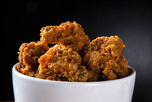 Bucket Full Of Crispy Kentucky Fried Chicken With Smoke On Brown Background. Selective Focus.