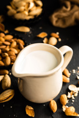 Wall Mural - Homemade almond milk in jug. Almond milk and almonds