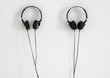 © Bojanikus - Modern black headphones hanging on white wall