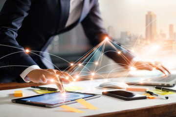 Businessman touching tablet and laptop. Managng global structure networking and data exchanges customer connection on workplace. Business technology and digital marketing network concept.