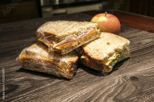 Sandwich Halves In Plastic Wrap With Apple Buy This Stock Photo