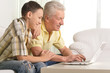 © aletia2011 - Grandfather with grandson using laptop at home