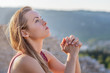 © PhotoGranary - Christian worship and praise. A young woman is praying with ruins in the background.