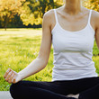 © Olesia - Girl meditates while practicing yoga outdoors in park