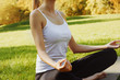 © Olesia - Girl meditates while practicing yoga outdoors in park