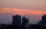 Fototapeta Miasto - Impressive sunset sky over the constructing area of Bangkok, Thailand 