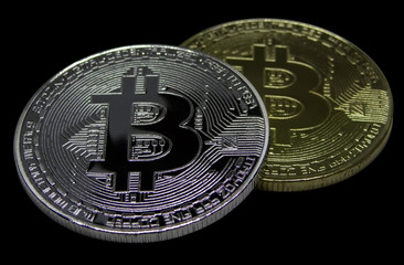 Bitcoin currency symbol silver and gold isolated on black