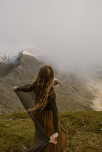 Woman On Top Of Mountain In The Clouds In Wales