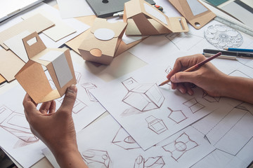 designer sketching drawing design brown craft cardboard paper product eco packaging mockup box devel