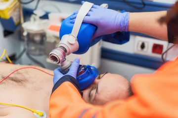 medical urgency in the ambulance. cardiopulmonary resuscitation using hand valve mask bag