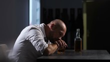 Middle Aged Alcoholic Man Thoughtful About Alcohol Addiction Drinking Indoors Leaning Hands On Whiskey Glass. Depressed Lonely Adult Businessman Drinking Whiskey Trying To Forget His Problems. Dolly.