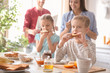 © Africa Studio - Little children having breakfast with toasts in kitchen