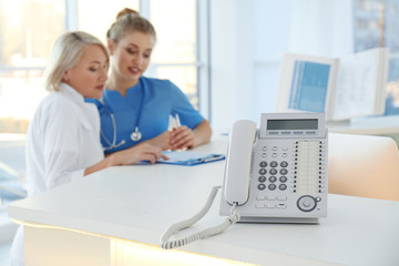 Sticker - Telephone and receptionist with trainee in hospital