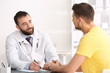 © Africa Studio - Doctor consulting male patient in clinic