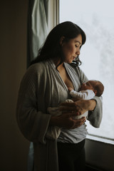 Wall Mural - mother holding her baby indoors
