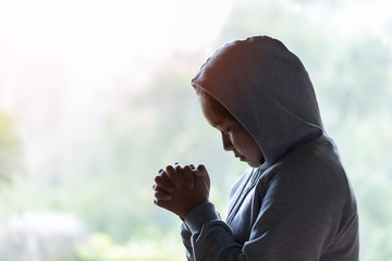 Young girl praying with holy bible in the morning. Woman praying to god. Christianity concept. Pray concept. Faith hope love concept.