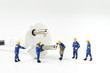 Sustainable energy, power consumption or electricity innovation concept, miniature people worker, technician help fixing or building electricity plug on white background with copy space