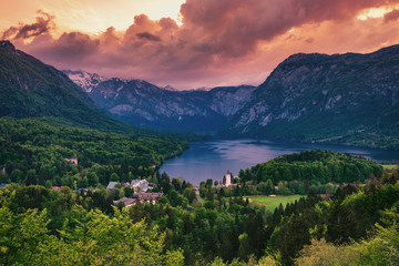 Aerial view of Bohinj lake in Julian Alps. Breathtaking view of the famous Bohinj lake from above. Beautiful view of the Triglav national park and the church of St John the Baptist. Slovenia, Europe