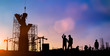 Silhouette of engineer and construction team working at site over blurred background for industry background with Light fair.Create from multiple reference images together