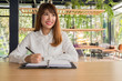 © I Believe I Can Fly - young businesswoman working with mobile laptop and documents in office, business concept