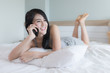 © SHUTTER DIN - woman Asian girl talking with friend on smartphone in bedroom on weekend