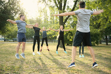 Group Of Sporty People Training In Park