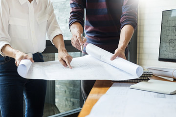 Wall Mural - professional architects working on blueprint discussing construction plans, engineer building, business co-working teamwork concept.