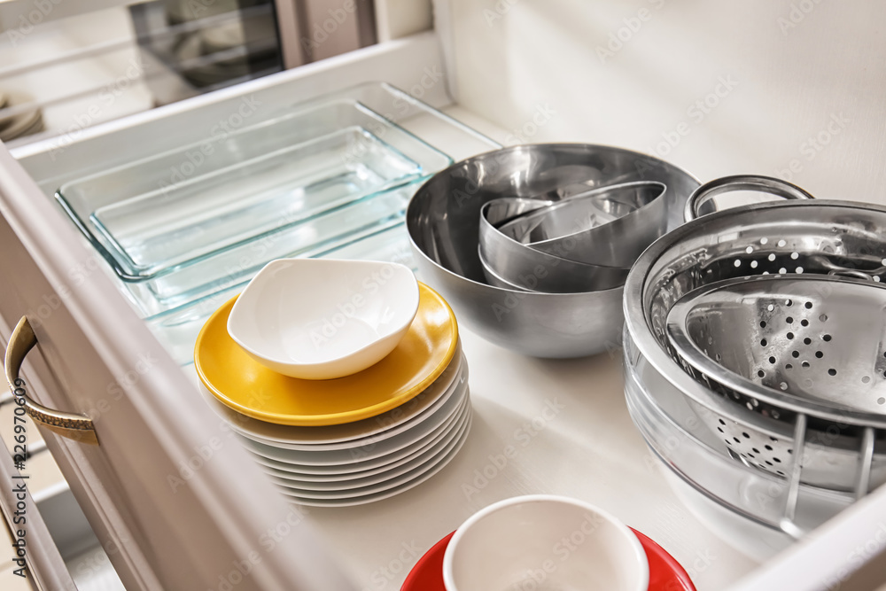 Set of clean kitchenware in drawer