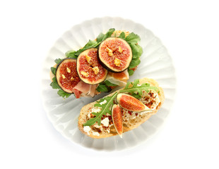 Tasty sandwiches with ripe fig on white background