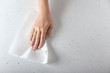 Woman wiping light table with paper towel