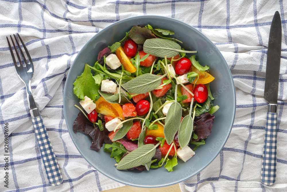 Plate with delicious watermelon salad on table