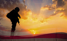 Double Exposure Silhouette Of Soldier On The United States Flag In Sunset For Veterans Day Is An Official USA Public Holiday Background,copy Space.