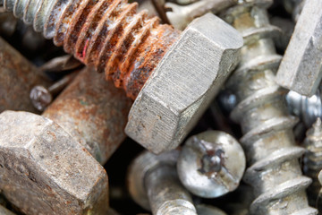 Close-up of old oxidized metal and copper screws and bolts   