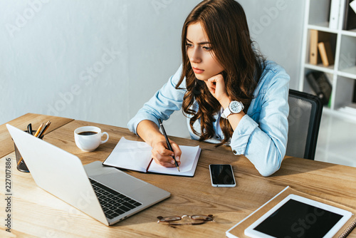 Cuadros en Lienzo concentrated woman at tabletop with laptop taking part in webinar in office