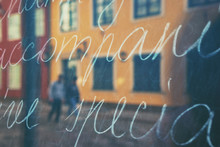 City In Reflection Of A Storefront With Text