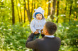 © izida1991 - dad and son for a walk in the park. Dad throws up baby