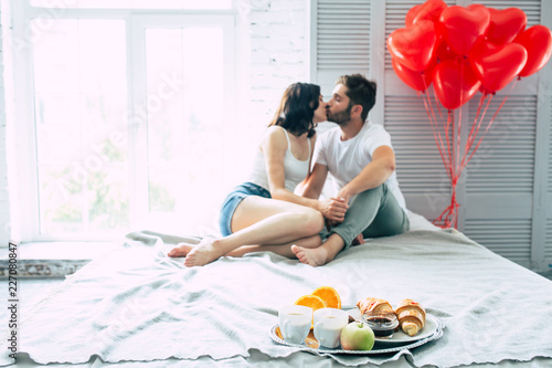 Happy Beautiful Cute Couple In Bedroom They Are Eating A