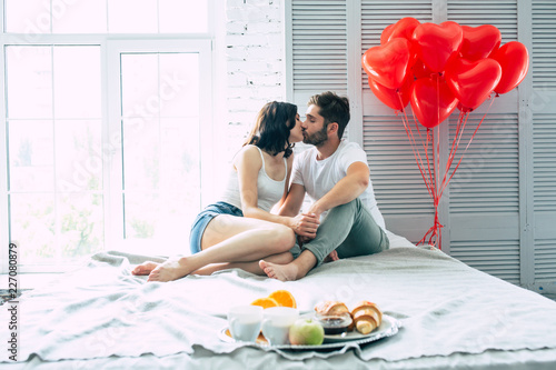 Happy Beautiful Cute Couple In Bedroom They Are Eating A