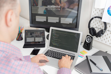 Programmer working on responsive website code