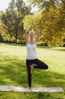 © Olesia - Girl practicing yoga outdoors in park