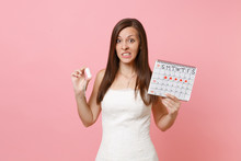 Bewildered Concerned Bride Woman In Wedding Dress Hold Tampon Female Periods Calendar For Checking Menstruation Days Isolated On Pink Background. Medical, Healthcare Gynecological Concept. Copy Space.