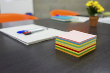 High Angle View Of Colorful Adhesive Notes With Pen And Documents On Conference Table