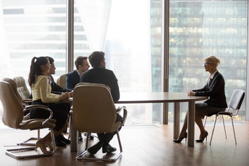 Wall Mural - Confident middle-aged female job applicant make good first impression at interview with millennial recruiter, young HR managers satisfied with mature woman candidate at work hiring. Employment concept